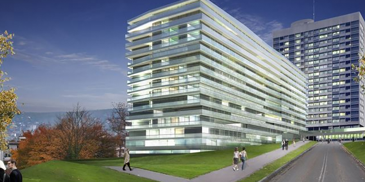 Bâtiment moderne de Stadtspitals Zürich avec une façade vitrée au premier plan et un gratte-ciel à l'arrière-plan.